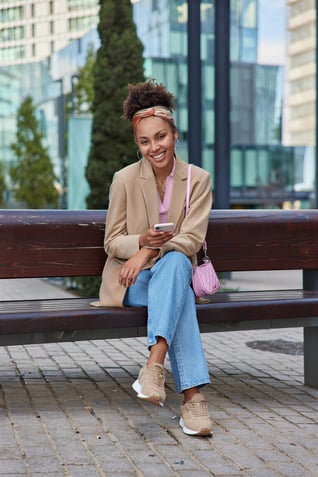 Customer sitting confidently on a bench in the city